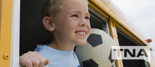 Happy Boy Riding the Bus with A Soccer Ball